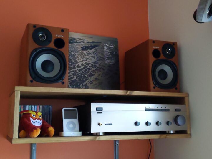 Two sony speakers with an amplifier under them