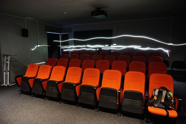 waves of light drawn above cinema seats.