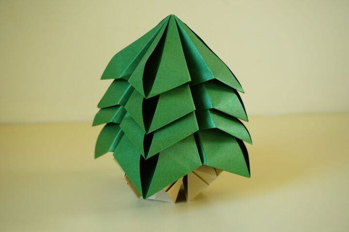 A green origami tree on a table